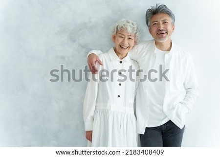 portrait of middle aged asian couple in white room