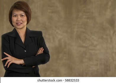 Portrait Of Middle Aged Asian Woman With Her Arms Crossed