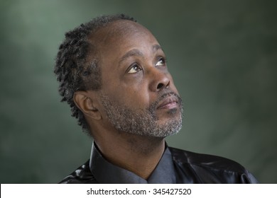 Portrait Of A Middle Aged Black Man, Eyes Look Up, Side Profile