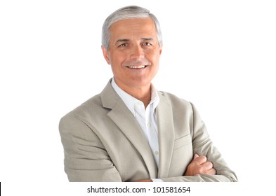 Portrait Of A Middle Aged Businessman With His Arms Folded Over A White Background. Man Is Smiling Wearing A White Shirt And Sport Coat.