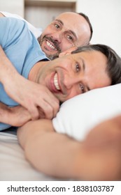 Portrait Of Middle Aged Homosexual Couple In Bed