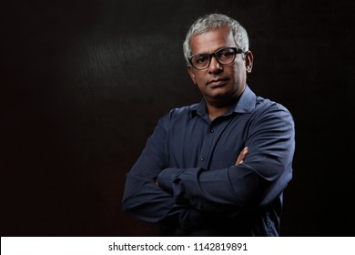 Portrait Of Middle Aged Man In A Dark Background