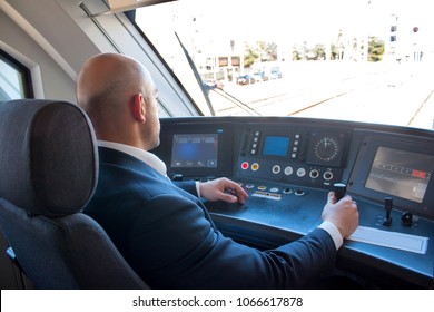 Portrait of middle aged man driving the modern train in Europe