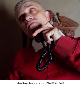 Portrait Of A Middle Aged Man Shaving With Electric Razor, Studio Shot