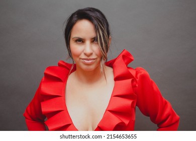 Portrait Of Middle Aged Mexican Woman Wearing Elegant Dress Looking At Camera Smiling Seductively