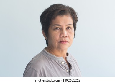 portrait of middle aged old woman with wrinkle skin and slight grey hair - Shutterstock ID 1392681212