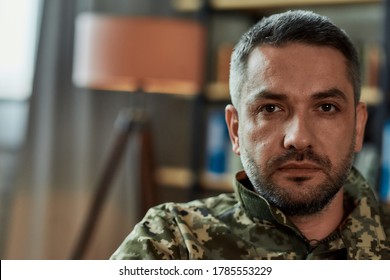 Portrait Of Middle Aged Sad, Desperate Military Man Looking Thoughtful At Camera During Therapy Session. Disabled Soldier Suffering From Depression Psychological Trauma. PTSD Concept. Horizontal Shot