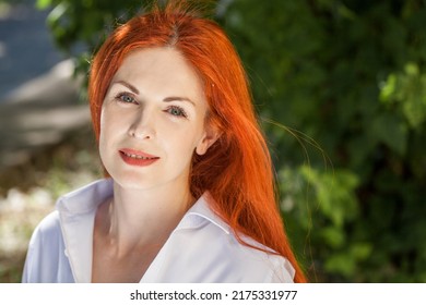 Portrait Of Middle Aged Woman With Dyed Red Hair