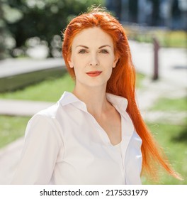 Portrait Of Middle Aged Woman With Dyed Red Hair