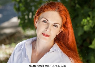 Portrait Of Middle Aged Woman With Dyed Red Hair