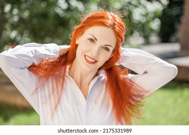 Portrait Of Middle Aged Woman With Dyed Red Hair