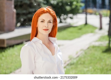 Portrait Of Middle Aged Woman With Dyed Red Hair