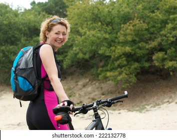 Portrait Of A Middle Aged Woman Smiling With Bike