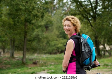 Portrait Of A Middle Aged Woman Smiling With Bicycle
