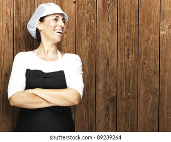 portrait of middle aged woman smiling against a wooden wall - Powered by Shutterstock