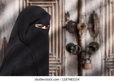 Portrait of a Middle Eastern woman wearing a black Niqab
Impossible to recognize this woman behind this complete attire
Only eyes can be seen in this scene due to the traditional chador garment