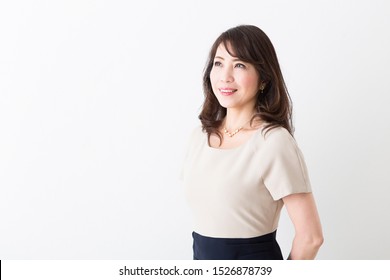 Portrait Of Middle Woman In Front Of White Wall