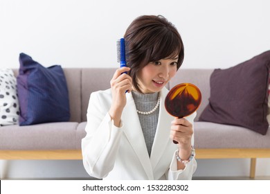 Portrait Of Middle Woman In Front Of White Wall