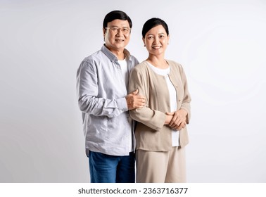 Portrait of middle-aged Asian couple posing on a white background - Powered by Shutterstock