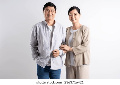 Portrait of middle-aged Asian couple posing on a white background - Powered by Shutterstock