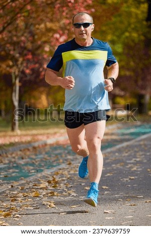 Similar – Blick auf den älteren Mann, der durch den Park joggt.