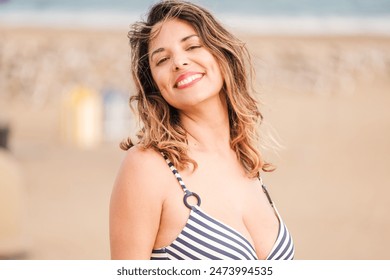 Portrait of middle-aged woman wearing striped bikini in dunes at sunset. Concept: vacation - Powered by Shutterstock