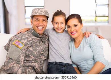 Portrait Of Military Family Sitting On The Couch At Home