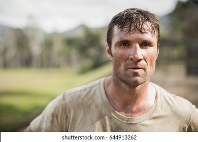 Portrait Of Military Man Standing During Obstacle Course In Boot Camp