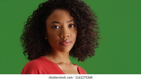 Portrait of millennial black female looking at camera on green screen - Powered by Shutterstock