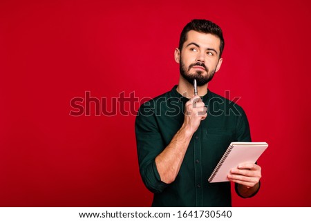 Portrait of minded guy write article in his copybook think thoughts look copyspace wear modern stylish outfit isolated over bright color background