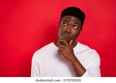 Portrait of minded intelligent person hand chin look interested empty space isolated on red color background - Shutterstock ID 2170720535