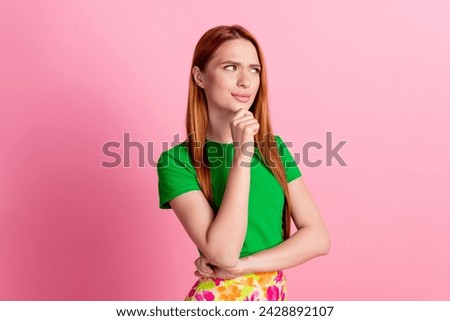 Portrait of minded pensive girl with redhead hairstyle wear stylish top thoughtfully look empty space isolated on pink color background