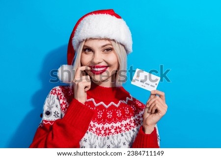 Portrait of minded pretty lady finger touch lip hold debit card newyear shopping isolated on blue color background