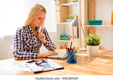 Portrait of minded woman holding bank card and doing shopping