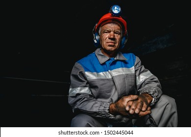 Portrait Miner Coal Man In Helmet With Lantern In Underground Mine. Concept Industrial Engineer.