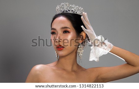 Portrait of Miss Pageant Beauty Contest in white gray sequin Evening Ball Gown dress sparkle light Silver Diamond Crown, Asian Woman fashion award, studio lighting dark background dramatic copy space