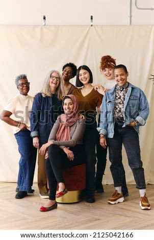Portrait of mixed age range multi ethnic women smiling in celebration of International Women's Day, Embrace Equity