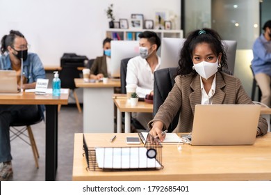 Portrait mixed race of African black and asian office worker wear face mask working in new normal office with social distance to Group of business team people to prevent coronavirus COVID-19 spreading