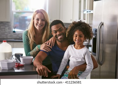 Portrait of mixed race couple and daughter in the kitchen - Powered by Shutterstock