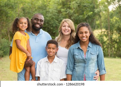 Portrait Of A Mixed Race Family Laughing.