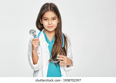 Portrait Of A Mixed Race Female Kid Wearing A Doctor Coat With Phonendoscope, Standing On White Background