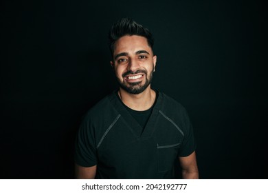 Portrait Mixed Race Male Nurse Smiling With Shiny Teeth For Portrait Against Black Back Drop