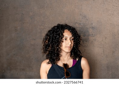 Portrait of a mixed race woman smiling while posing inside an abandoned factory. - Powered by Shutterstock