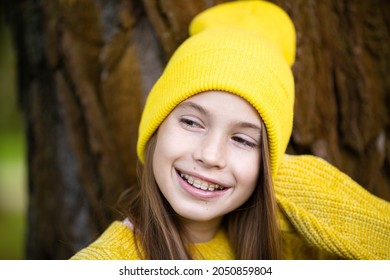 Portrait Of Modern Happy Teen Girl With Dental Braces Dressed In Yellow Clothes In Park. Pretty Teenage Girl Wearing Braces Smiling Cheerfully. Kid Girl In Autumn Smiling With Braces Teeth Apparatus.