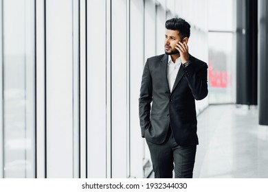 Portrait Of A Modern Indian Man, Asian Appearance, He Steps On A Business Meeting, Office Worker, Bank Employee, Boss. Holding.