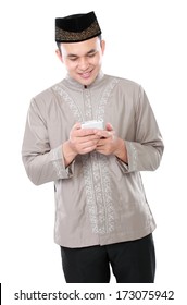 Portrait Of Modern Muslim Man Holding Mobile Phone Isolated Over White Background