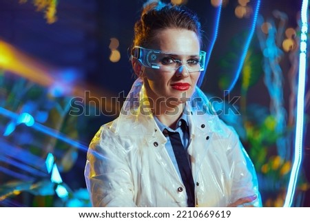 Portrait of modern scientist woman in lab coat with futuristic goggles in virtual reality.