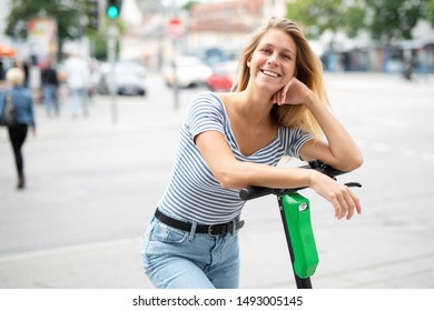 
Portrait of a modern young woman with e-scooter