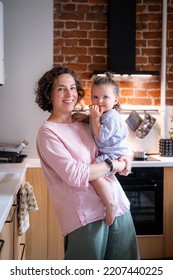 Portrait Mom With Baby Girl On Her Hands At Kitchen At Home, Domestic Chores At Maternity Leave, Cooking Together, Happy Family Mother Day