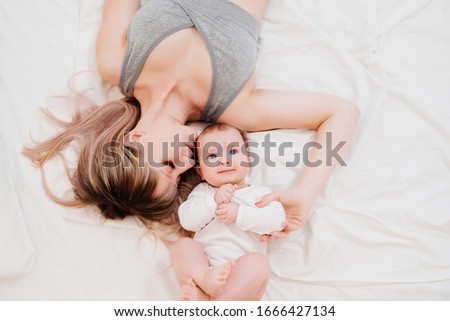 Similar – Mother hugging her newborn baby girl